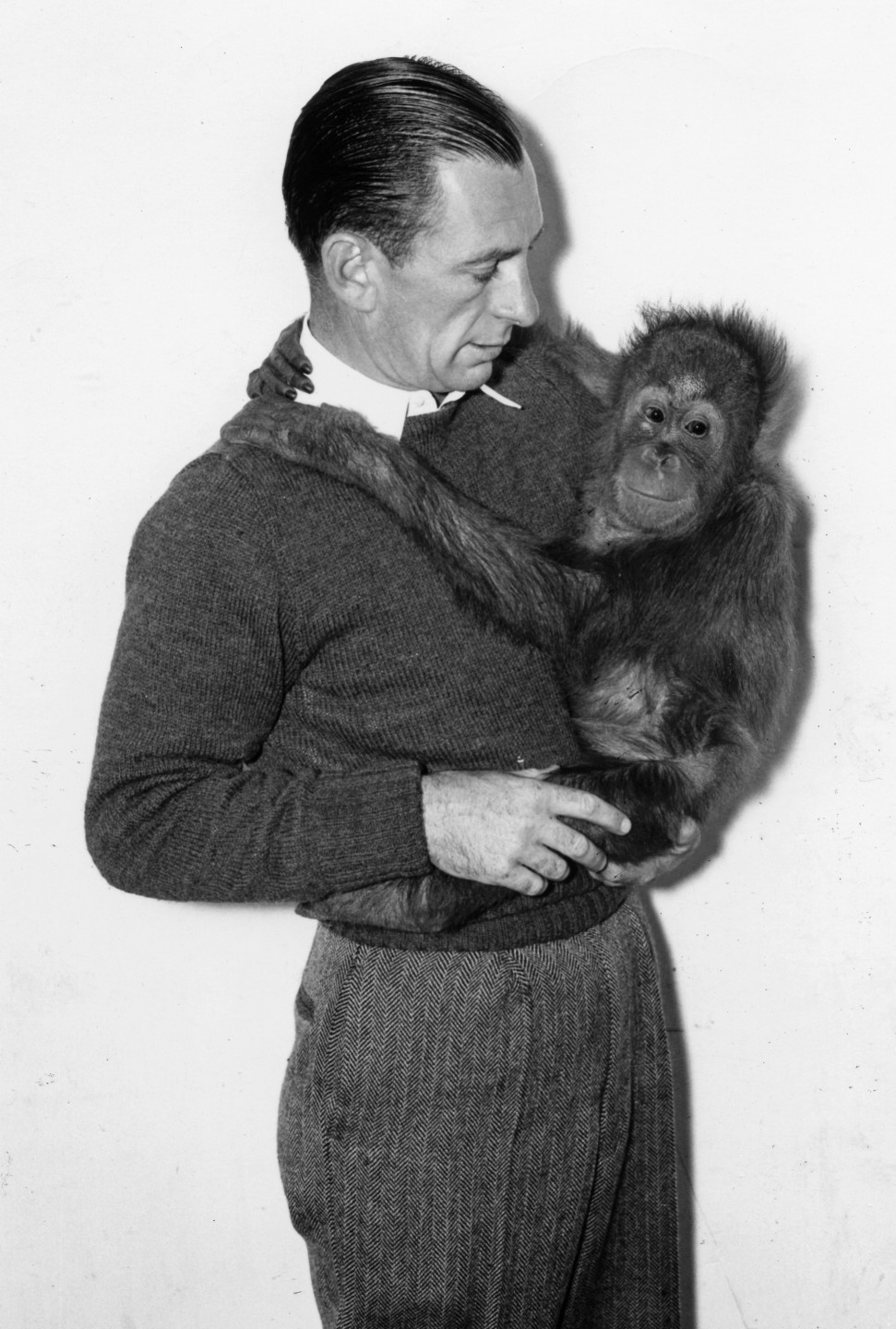San Diego Zoo keeper Howard Lee with a young orangutan.