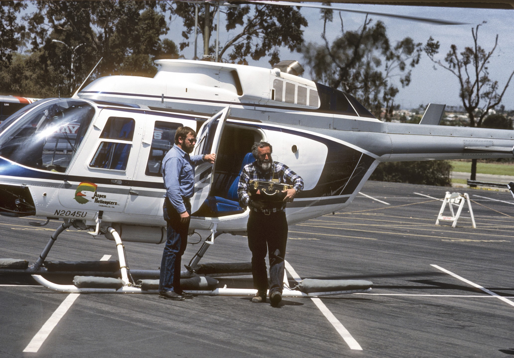 The helicopter arrives bringing a California condor egg to the San Diego Zoo's Avian Propagation Center for hatching on February 23, 1983. Noel Snyder of the U.S. Fish & Wildlife Service carries the precious cargo in a padded egg case. This event was the result of an agreement between the San Diego Zoo, the Los Angeles Zoo, the National Audubon Society, the U.S. Fish & Wildlife Service, and the California Department of Fish & Game to remove eggs from the five known pairs of California condors left in the wild and bring them to zoos for hatching and raising.