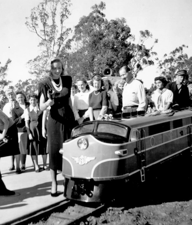 Actress Janice Page dedicates the train on its inaugural run with the ceremonial breaking of a bottle of champagne.