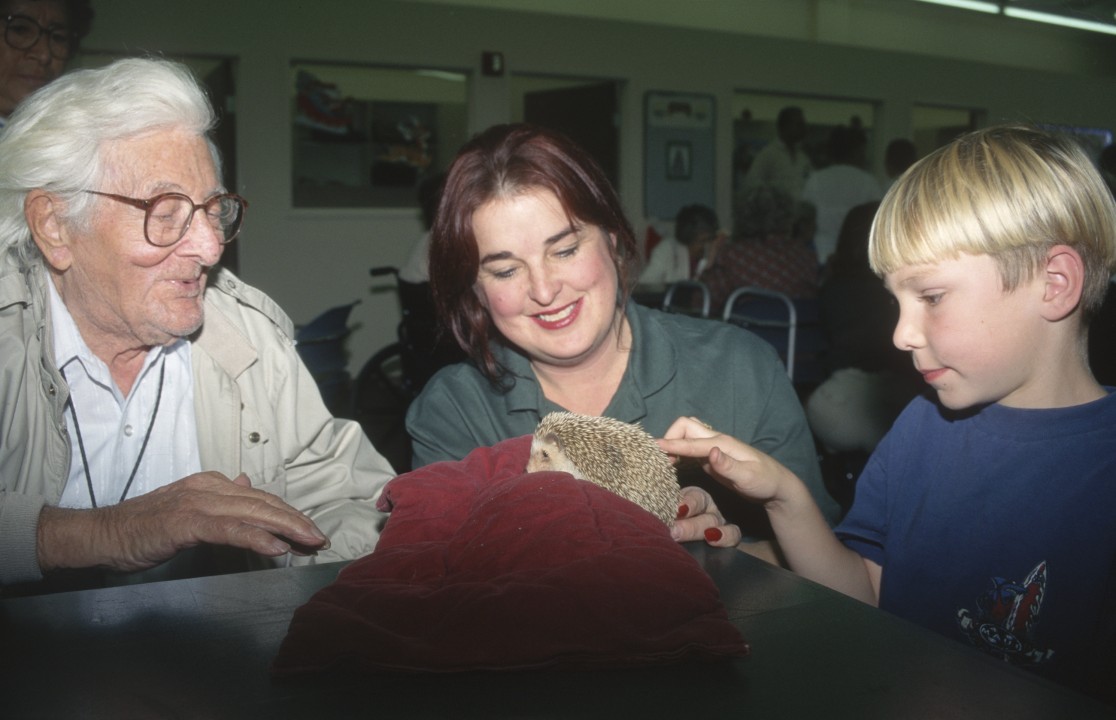 Keeper Shari McDonald shares a hedgehog friend with two generations during a Zoo Express visit.