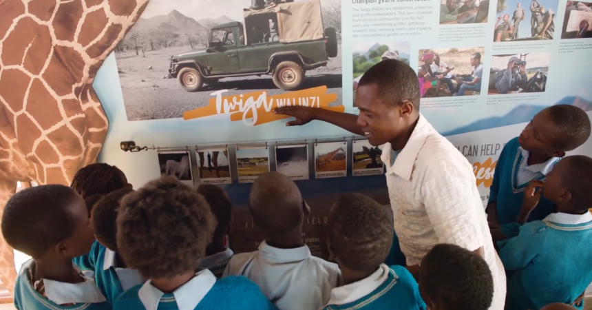A group of schoolchildren learns about the giraffe research project.